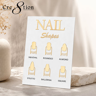 Cre8tion nail shapes display card showing six gold tip shapes, squoval through square, propped on stone.