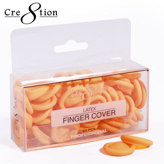 Clear Cre8tion box packed with peach latex finger covers, two loose rings resting beside it.