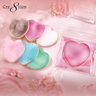Heart shaped Cre8tion agate palettes in gray, pink, white and mint on pink silk, one still bagged.