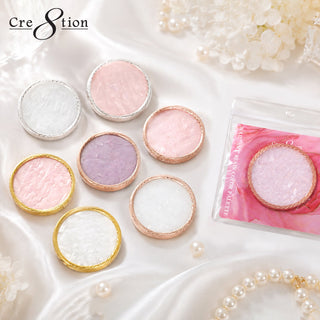 Round Cre8tion nail art palettes with gold rims in white, pink and lilac, on silk with pearls.