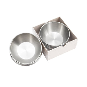 Stack of silver Cre8tion pedicure bowls beside a white box holding one more silver bowl.