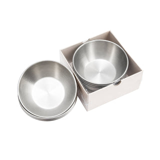 Stack of silver Cre8tion pedicure bowls beside a white box holding one more silver bowl.