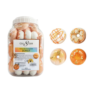 Jar of Cre8tion donut pedicure soak bombs beside four loose donuts with caramel drizzle and sprinkles.
