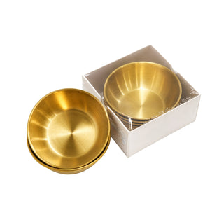 Stack of gold Cre8tion pedicure bowls beside a white box holding one more gold bowl.