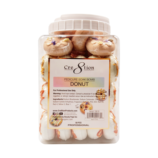 Clear jar of Cre8tion 40g Donut pedicure soak bombs molded as cream and caramel glazed donuts.