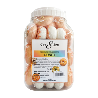 Clear jar of Cre8tion 60g Donut pedicure soak bombs in cream and caramel glazed donut shapes.