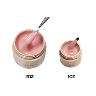 Cre8tion Soft Afternoon builder gel in 2oz and 1oz gold jars, a spatula lifting warm rose gel.