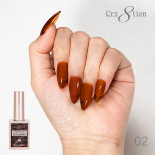 Hand with rust brown blooming gel nails beside the Cre8tion Blooming Gel 02 bottle.