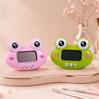Two Cre8tion frog digital timers with big cartoon eyes, one pink and one green.