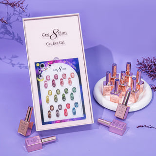 Cre8tion Back To The Moon cat eye chart in an open box on purple, rose gold bottles on a round riser.