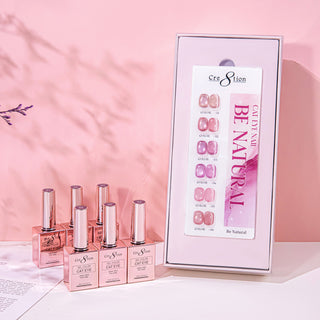 Cre8tion Be Natural cat eye box open to a chart of six nude swatch nails, rose gold bottles beside it.