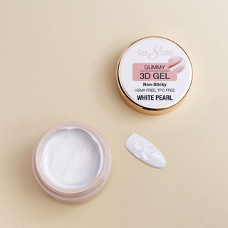 Open jar of Cre8tion Gummy 3D gel in White Pearl with a shaped bead of gel beside it.